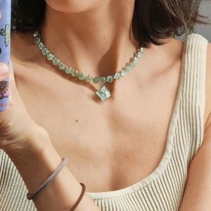 Light green choker necklace and earrings set with green stone jewels